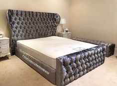 a bedroom with a bed, night stand and two nightstands in the corner on carpeted flooring