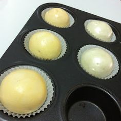 four cupcakes in a muffin tin ready to be baked into the oven