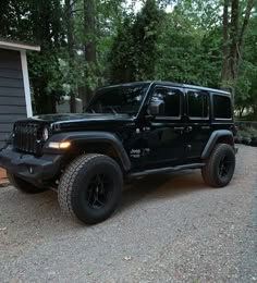 a black jeep parked in front of a house