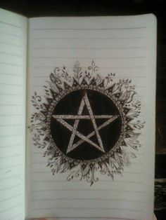 an open notebook with a pentagramil drawn on it