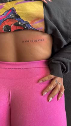 a woman's lower back tattoo with the words
