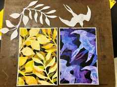 some paper cut outs with leaves and birds on them
