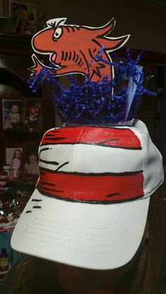 a cat in the hat with blue flowers on top