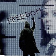 a person standing in front of a screen with the word freedom written on it and an image of a woman holding her hand up