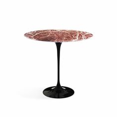 an oval marble table with black base and pink marble top, on a white background