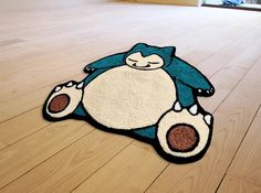 a blue and white rug with an angry cat on it's back laying on the floor