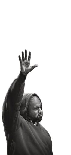 a black and white photo of a man reaching up to catch a frisbee