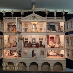 a doll house with furniture and accessories on display