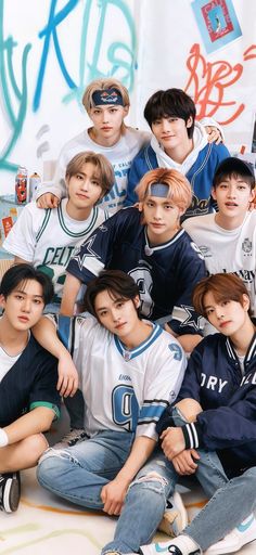 the boys are posing together in front of graffiti