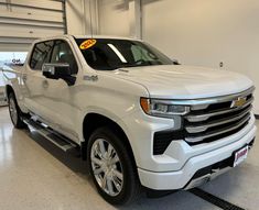 a white truck is parked in a garage