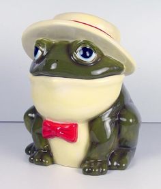 a ceramic frog with a hat and bow tie