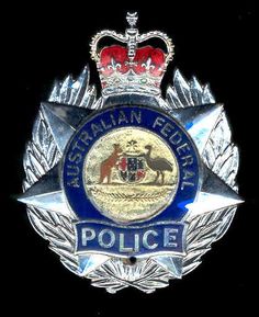 an emblem on the back of a police badge with a crown and kangaroo in it