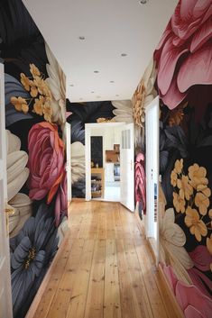 the hallway is decorated with floral wallpaper and wood flooring