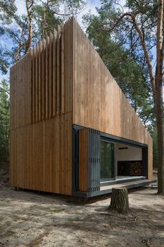 the house is made out of wood and has been designed to look like a triangular structure