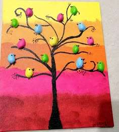 a tree with birds painted on it sitting in front of a pink and yellow background