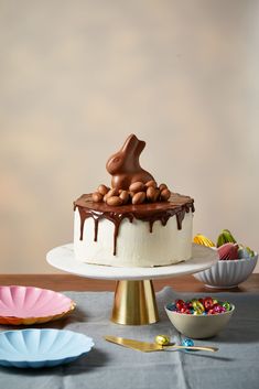 there is a cake with nuts and chocolate on the top, surrounded by other desserts