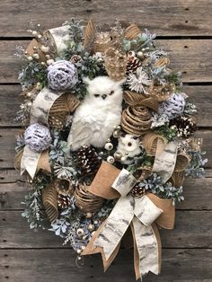 a wreath with an owl and pine cones