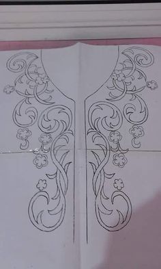 an open book with intricate designs on it