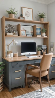 a desk with a computer on top of it and some potted plants next to it