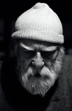 black and white photograph of an old man wearing a beanie hat with his eyes closed