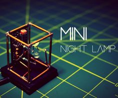 a miniature machine is sitting on a table with the words mini night lamp above it