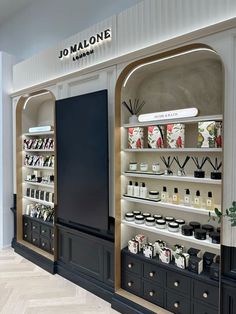 the inside of a store with shelves filled with bottles and vases on it's sides