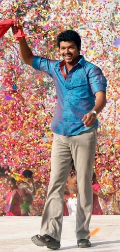 a man standing in front of confetti covered wall