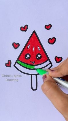 someone is drawing a watermelon on paper