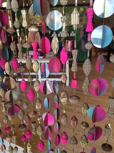 a room filled with lots of different colored objects hanging from it's walls and ceiling