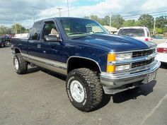 a blue pickup truck parked in a parking lot