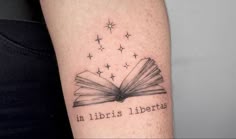 an open book with the words in libris liberas written on it