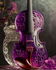 a purple violin sitting on top of a table next to a vase filled with flowers