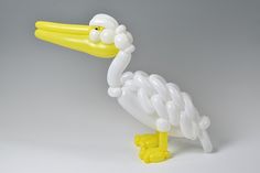a balloon sculpture of a pelican on a white background