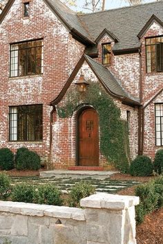 an old brick house with ivy growing on it