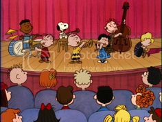 the peanuts gang on stage playing musical instruments