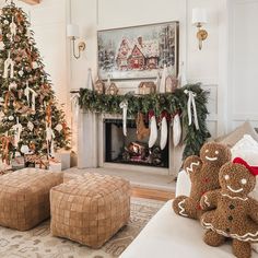 a living room decorated for christmas with stockings and teddy bears in front of the fireplace