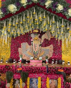 an idol is surrounded by flowers and garlands