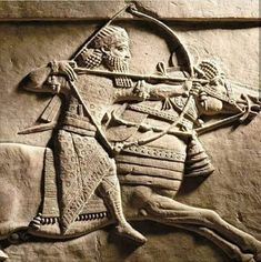 an ancient sculpture depicting a man on horseback with a bow and arrow