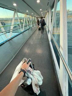 a person is taking a photo with their cell phone on a bridge over looking the water