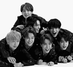 the group of young men are posing together for a black and white photo with their mouths open