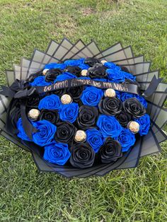 a bouquet of blue and black roses on the grass