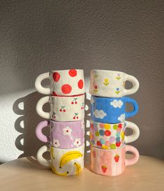 four coffee mugs stacked on top of each other