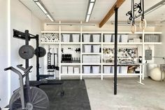 a gym with several exercise equipment in the middle of it's storage area,
