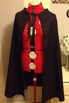 a red and black cape with buttons on it