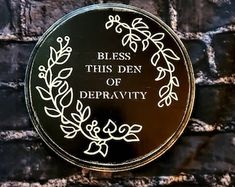a plaque on the side of a brick wall that reads, blessing this den of depravity