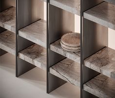 the shelves are lined with marble plates and bowls