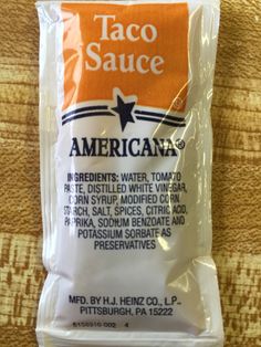 taco sauce packet sitting on top of a table