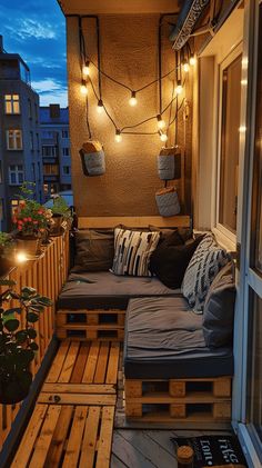 a balcony with wooden pallets and lights strung from the ceiling, couches made out of wood planks