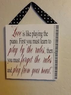a sign hanging on the wall that says love is like playing the piano first you must learn to play by the rules
