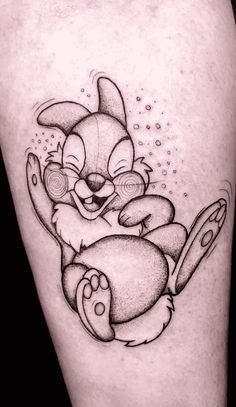 a cartoon character tattoo on the leg of a woman's leg, with an image of a rabbit